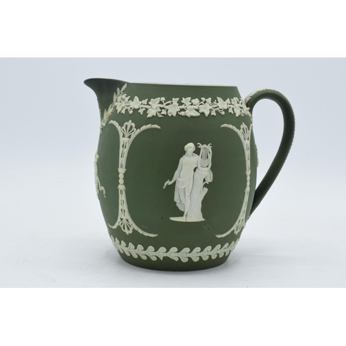 82 - Early Wedgwood green Jasperware ovoid jug with traditional scenes, 15cm tall.