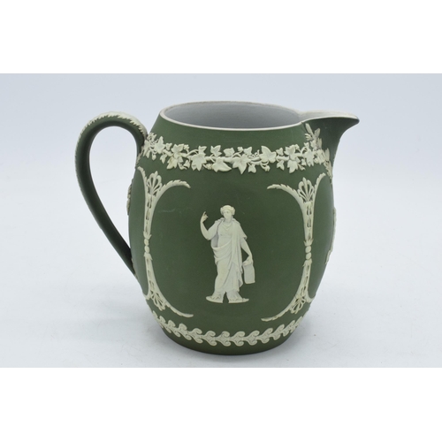 82 - Early Wedgwood green Jasperware ovoid jug with traditional scenes, 15cm tall.