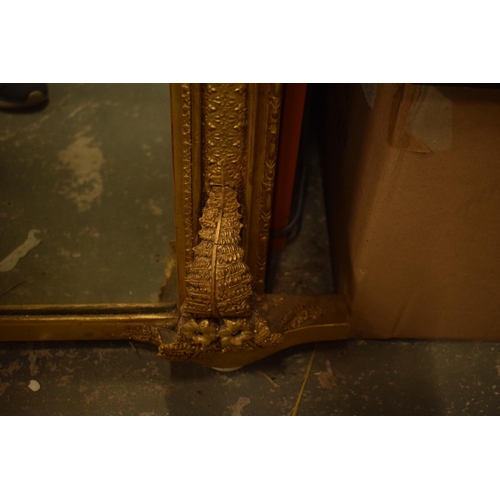 376 - 19th century over mantel mirror of arched form with gilt moulded frame with fern detail, 114cm wide.