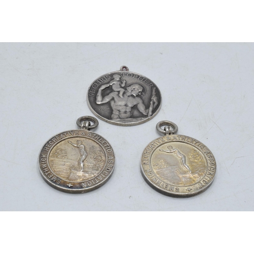 205C - A trio of silver medallions / fobs to include 2 athletic and a St Christopher (3), 41.5 grams.