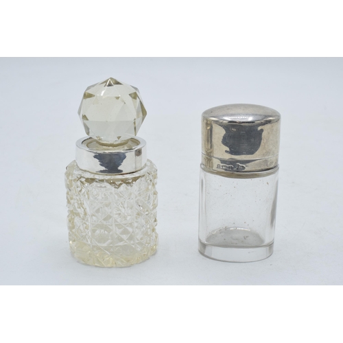 205F - Silver lidded / hinged oval scent bottle together with silver rimmed scent bottle (2). 8.5cm tall.