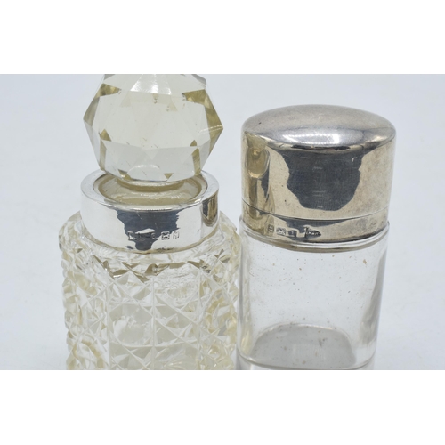 205F - Silver lidded / hinged oval scent bottle together with silver rimmed scent bottle (2). 8.5cm tall.