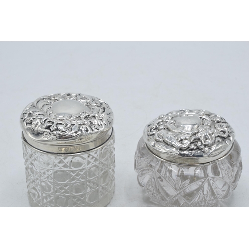 205G - A trio of Edwardian hallmarked silver lidded glass jars to include Chester 1911, 1905 and Birm 1902 ... 