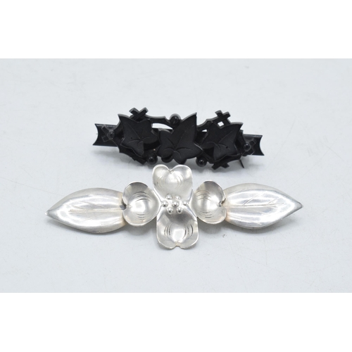 205I - A pair of vintage brooches to include white metal stylised floral brooch and a vulcanite ivy brooch ... 