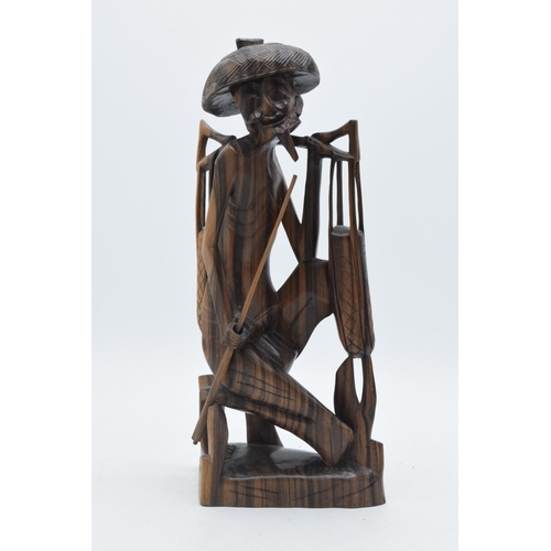 298A - 20th century Eastern wooden tribal-style carving of a water carrier / fisherman, 31cm, signed 'REDIG... 