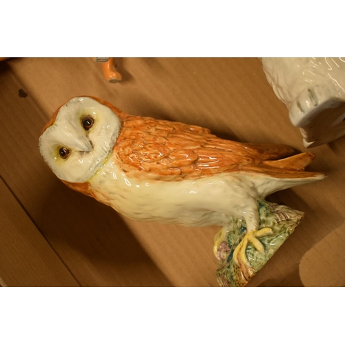 109 - A collection of Beswick to include a large barn owl, Boxer dog, bald eagle (slight damage to wing) a... 