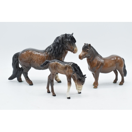 138 - A trio of Beswick brown horses to include Shetland, Shetland foal and head down pony (3).