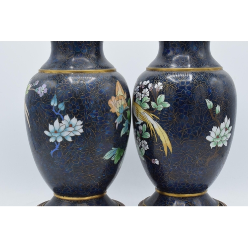 238 - A boxed pair of Chinese cloisonne vases with birds amongst foliage with rich blue background on wood... 