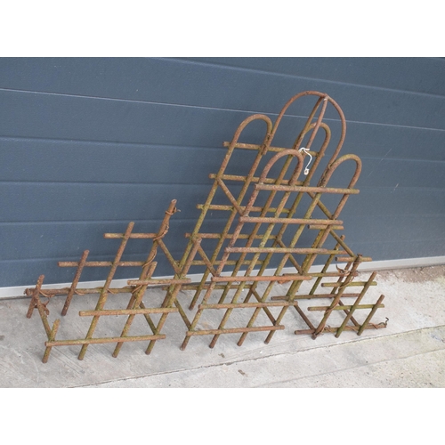 239 - A trio of vintage bent metal wine bottle holders in the form of an arched example and 2 small items,... 