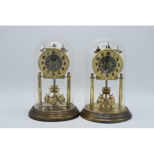 266 - A pair of vintage anniversary clocks in domed cases, ticking order (2).