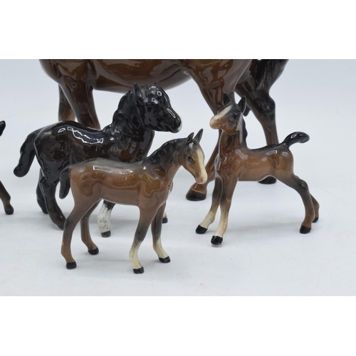 81 - A collection of brown Beswick horses and foal to include mare facing left 976, Shetland foal and oth... 