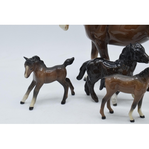 81 - A collection of brown Beswick horses and foal to include mare facing left 976, Shetland foal and oth... 