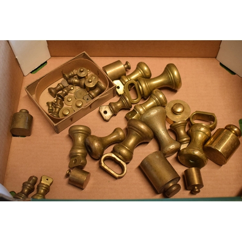 292 - A collection of brass weights of varying forms and sizes.