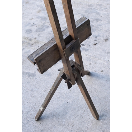 304 - Early 20th century folding artist's easel with heavy duty wingnut and remnants of paint, 190cm tall ... 