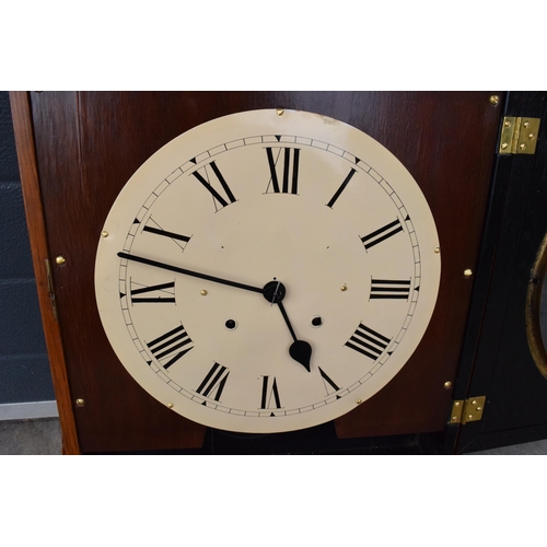 312 - 20th century wooden cased wall clock, in the style of Seth Thomas, with key and pendulum. 58cm long.