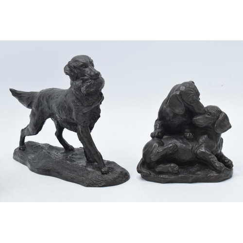 16B - A trio of bronze-effect resin country figures to include spaniels carrying game and others (3), larg... 