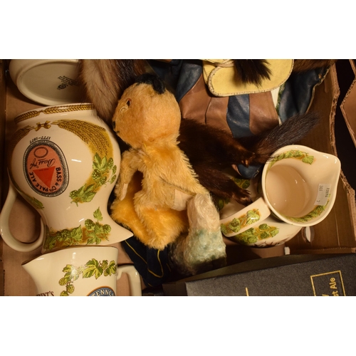 208 - A collection of items to include Bass pub jugs, 1950s Sooty hand puppet, mink stoles and others.