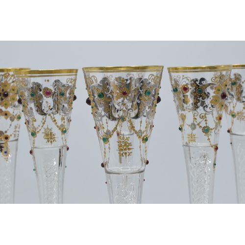 210 - A set of 6 tall glass champagne flutes with swirl, gilt and stone-like decoration (6), 24cm tall.