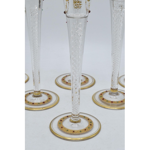 210 - A set of 6 tall glass champagne flutes with swirl, gilt and stone-like decoration (6), 24cm tall.