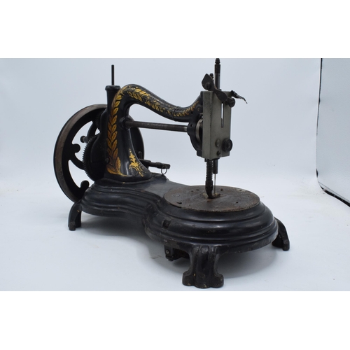 245 - Antique hand-propelled Jones & Company hand sewing machine, 38cm long.