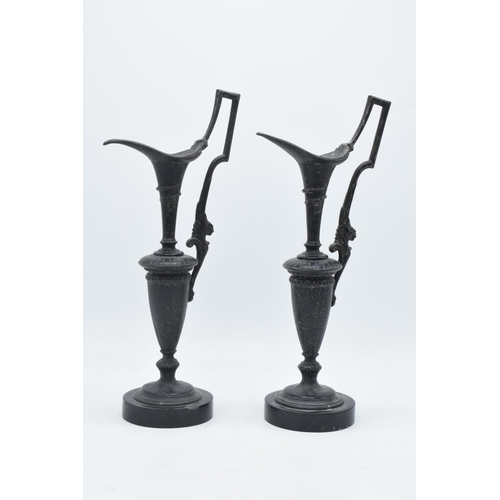 259 - A pair of attractive spelter vases with figural handles on slate bases (2), 31cm tall.