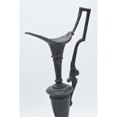 259 - A pair of attractive spelter vases with figural handles on slate bases (2), 31cm tall.