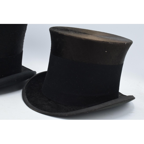 348 - A pair of black gentleman's top hats, one 'Best Quality London, opening 18x15cm, and the other Bayne... 