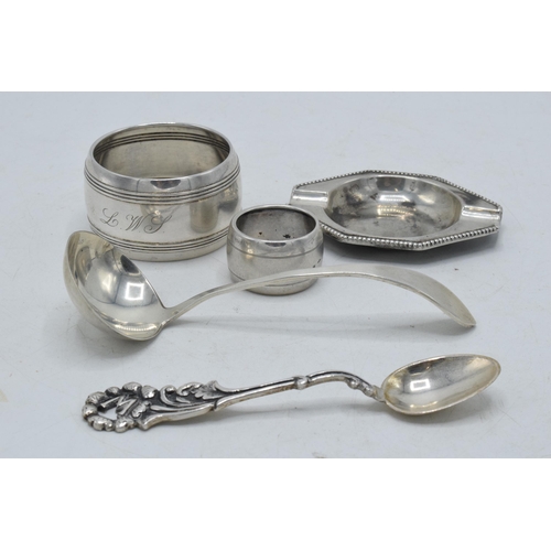 41 - A collection of continental silver items to include small ashtray, napkin rings, a spoon and one sim... 