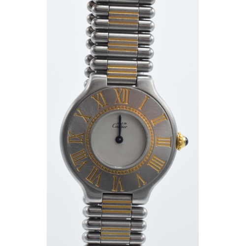 126 - Cartier bi-colour wristwatch with Roman numerals with cabachon sapphire crown, 28mm wide.