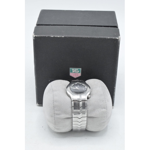 129 - Boxed Tag Heuer steel wristwatch with black dial, with box and papers, in working order.