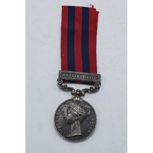 142 - Queen Victoria silver Hazara 1891 medal inscribed with native's name serving for British Army.