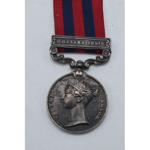 142 - Queen Victoria silver Hazara 1891 medal inscribed with native's name serving for British Army.