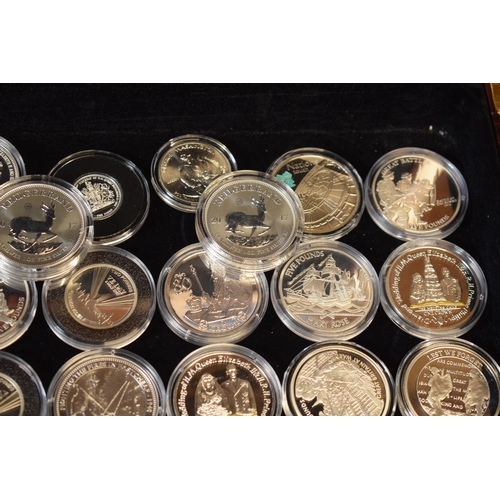 16 - A collection of cased modern silver coins to include 1 oz Fine Silver Kruggerands, £5 coins and vari... 