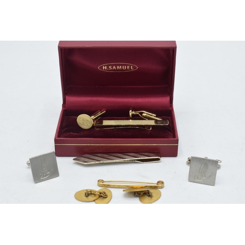 179 - Boxed H Samuel cufflinks and tie clip set together with similar items.