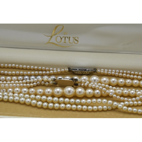 181 - A pair of double row cultured pearl necklaces, one with silver clasp (2).