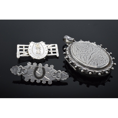 182 - Large silver locket together with 2 horse-themed Victorian silver sweetheart brooches (3).