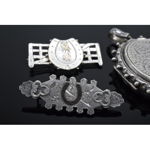 182 - Large silver locket together with 2 horse-themed Victorian silver sweetheart brooches (3).