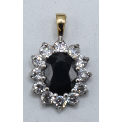 199 - 9ct gold and white gold pendant set with a sapphire and CZs, 1.5 grams, 20mm tall.