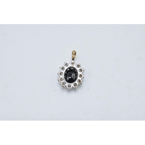 199 - 9ct gold and white gold pendant set with a sapphire and CZs, 1.5 grams, 20mm tall.