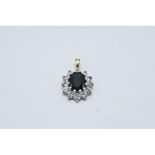 199 - 9ct gold and white gold pendant set with a sapphire and CZs, 1.5 grams, 20mm tall.