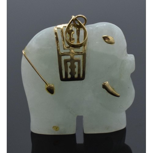 206 - 9ct gold mounted jade (or similar) pendant in the form of an elephant with 9ct gold decoration, 35mm... 