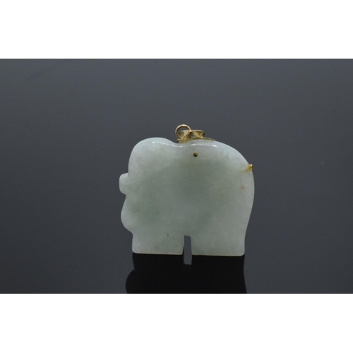 206 - 9ct gold mounted jade (or similar) pendant in the form of an elephant with 9ct gold decoration, 35mm... 