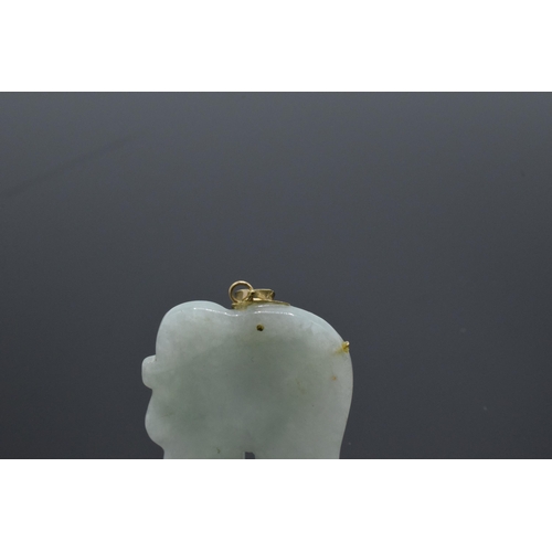 206 - 9ct gold mounted jade (or similar) pendant in the form of an elephant with 9ct gold decoration, 35mm... 