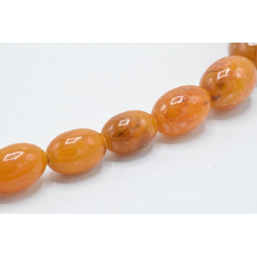 208 - A butterscotch amber (or similar) single-row necklace of graduating amber beads, approximately 37cm ... 