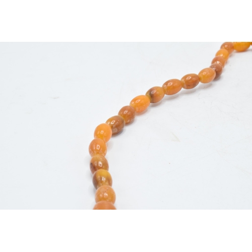 208 - A butterscotch amber (or similar) single-row necklace of graduating amber beads, approximately 37cm ... 