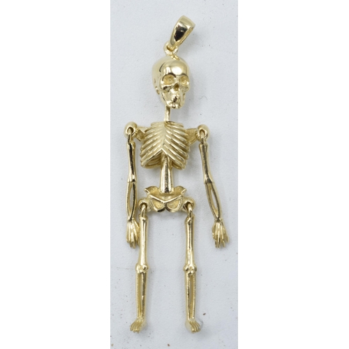 211 - 9ct gold pendant in the form of an anatomical skeleton. 2.4 grams. 4.5cm tall.