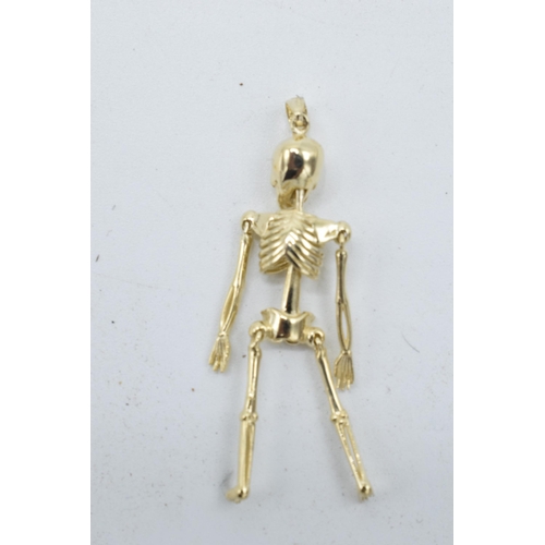 211 - 9ct gold pendant in the form of an anatomical skeleton. 2.4 grams. 4.5cm tall.