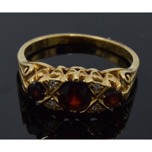 225 - 18ct gold diamond and garnet ring, 3.8 grams, size P.