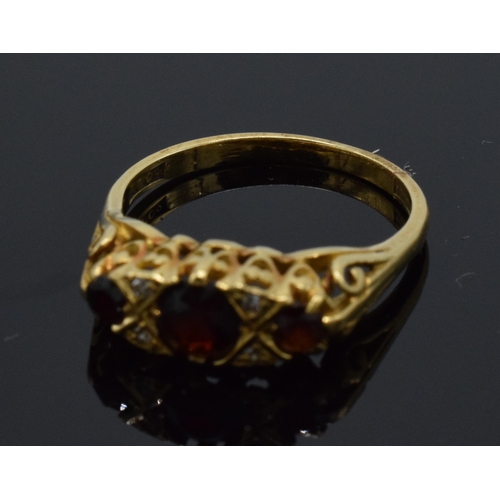 225 - 18ct gold diamond and garnet ring, 3.8 grams, size P.