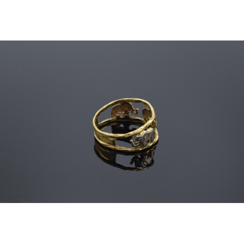 240 - 18ct gold and white gold ring with walking elephants, 3.3 grams, size P/Q. No hallmarks but it tests... 